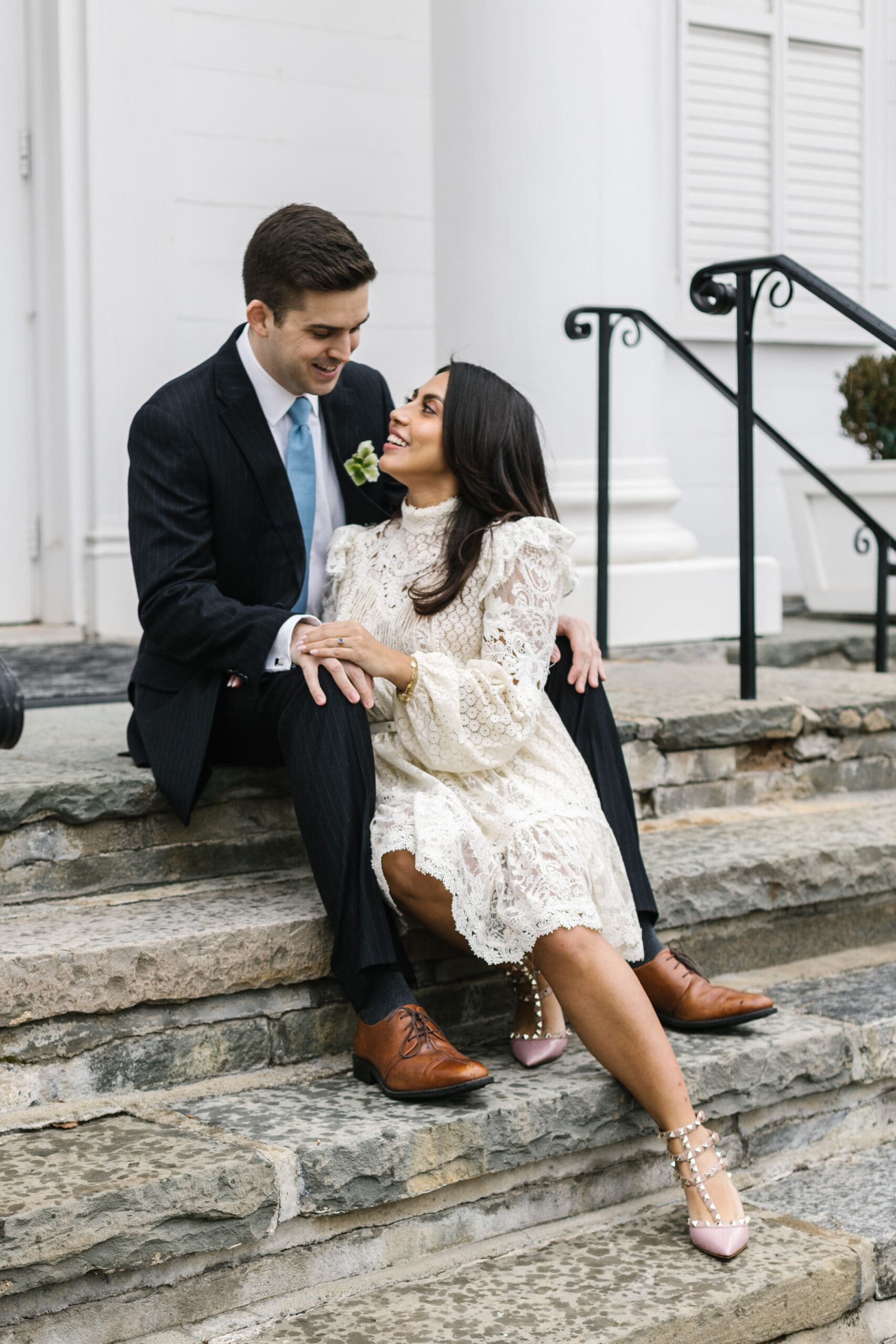 Couple setting on steps on church in downtown westport, CT